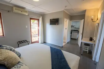 a living room with a bed and a kitchen at Greenwaywoods Unit 11 in White River