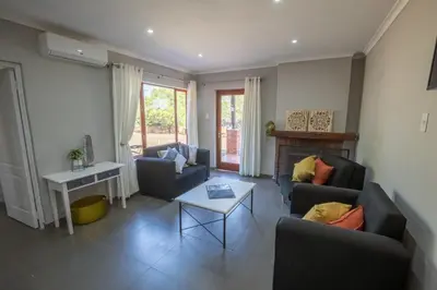 a living room with two couches and a fireplace at Greenwaywoods Unit 11 in White River