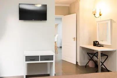 a room with a desk and a tv on a wall at Greenwaywoods Unit 11 in White River
