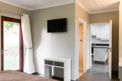 a bedroom with a television on a wall with a bed at Greenwaywoods Unit 11 in White River