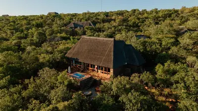 an overhead view of a house in the middle of a forest at Dinkweng Safari Lodge in The Waterberg Biosphere