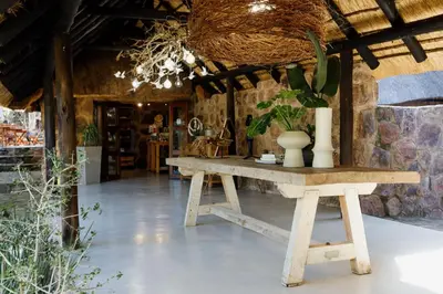 a table with a vase on it in a room at Dinkweng Safari Lodge in The Waterberg Biosphere