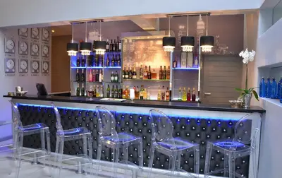 a bar with blue bar stools in a room at Blue Diamond Boutique Hotel in Pretoria