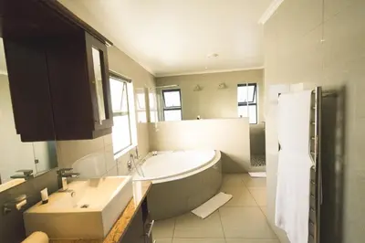 a large bathroom with a tub and a sink at Blue Diamond Boutique Hotel in Pretoria