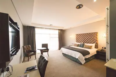 a hotel room with a bed and a television at Blue Diamond Boutique Hotel in Pretoria