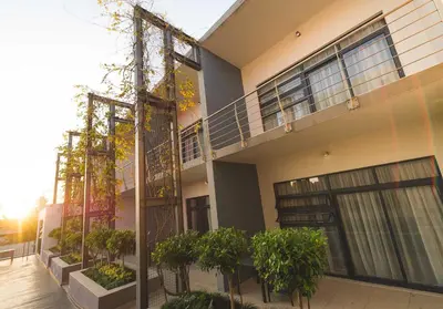 a building with trees in front of it at Blue Diamond Boutique Hotel in Pretoria