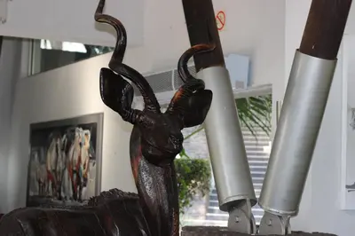a statue of a person holding two rolls of paper at Ecolux Boutique Hotel in Komatipoort