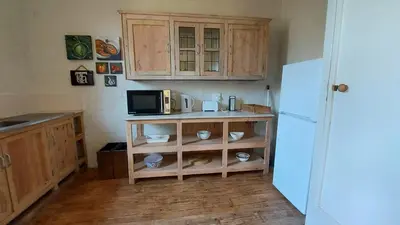 a kitchen with a microwave and a refrigerator at Bluebell Barn in Dullstroom