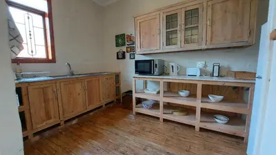 a kitchen with wooden cabinets and a microwave at Bluebell Barn in Dullstroom