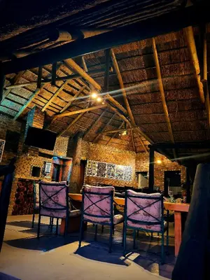 a room with three purple chairs and a table at Cycad Place Midrand Guesthouse and B&B in Midrand