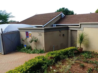a house with a gate and a fence at Love Joy Peace Cottage in Pretoria