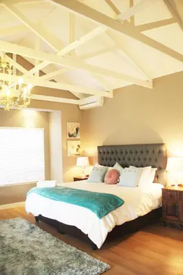 a bedroom with a large bed with a large ceiling at BELLA ROSA FARM in Midrand