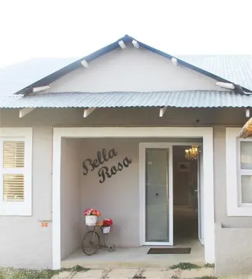 a building with a bike parked in front of a garage at BELLA ROSA FARM in Midrand