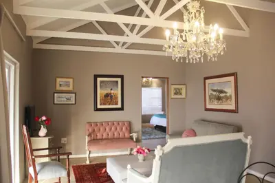 a living room with a chandelier and a dining room at BELLA ROSA FARM in Midrand