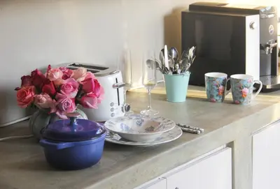 a counter with cups and plates and flowers on it at BELLA ROSA FARM in Midrand