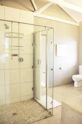 a glass shower in a bathroom with a toilet at BELLA ROSA FARM in Midrand
