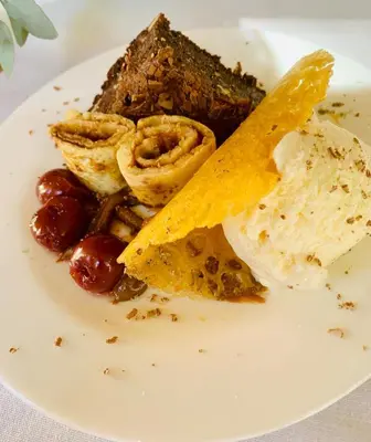 a plate of food with a piece of meat and fruit at Morgenzon Estate in Pretoria