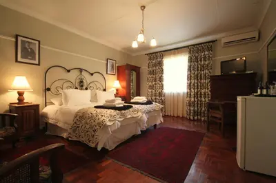 a bedroom with a bed and a dresser and a window at Morgenzon Estate in Pretoria