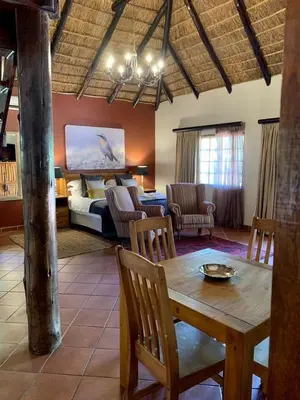 a living room with a bed and a table and chairs at Morgenzon Estate in Pretoria