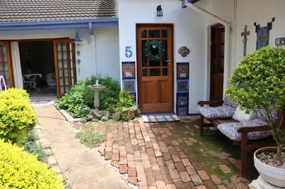 a front door of a house with a brick patio at Mia's in Tzaneen