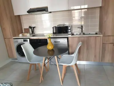 a kitchen with a table and chairs in a kitchen at The Blyde Lagoon, Pretoria in Pretoria