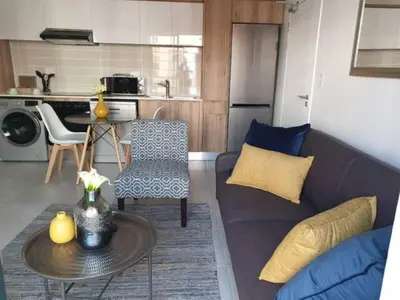 a living room with a couch and a table at The Blyde Lagoon, Pretoria in Pretoria