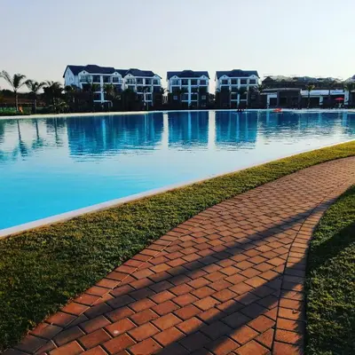 a brick walkway next to a large body of water at The Blyde Lagoon, Pretoria in Pretoria
