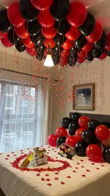 a table with red and black balloons and a cake at The Blyde Lagoon, Pretoria in Pretoria