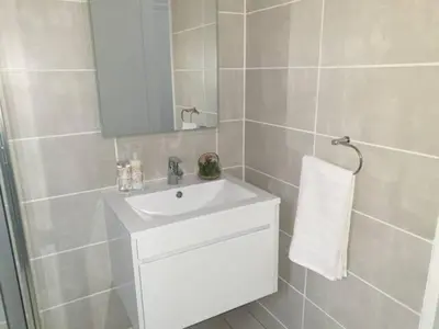 a bathroom with a white sink and a mirror at The Blyde Lagoon, Pretoria in Pretoria