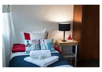 a bedroom with a bed with towels on it at Anchor Guesthouse in Secunda