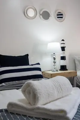 a bedroom with a bed with a pile of towels on it at Anchor Guesthouse in Secunda