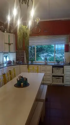 a kitchen with a large wooden table with a bench at Eagle's Nest in Barberton