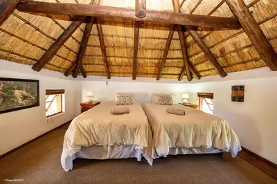 a bedroom with two beds in a room at Niani villa in Hoedspruit