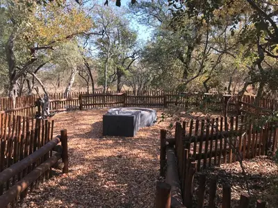 a wooden fence with a mattress in a yard at Niani villa in Hoedspruit