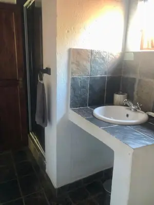 a bathroom with a sink and a blue counter top at Niani villa in Hoedspruit