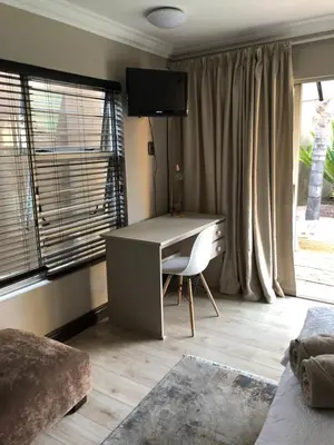 a desk in a room with a window at Annies Place Self Catering in Kempton Park