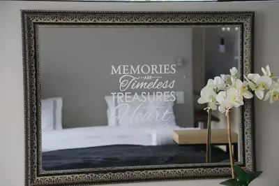 a mirror in a frame in a bedroom with a bed at Memories Made Cottage in Kampersrus AH