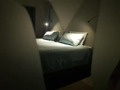 a bed with two pillows in a small room at Memories Made Cottage in Kampersrus AH