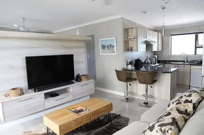 a living room with a flat screen tv on a wall at Memories Made Cottage in Kampersrus AH