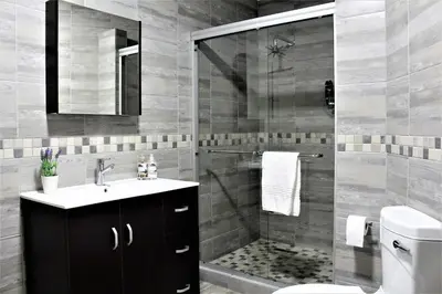 a bathroom with a shower and a sink and a toilet at @Home in the East in Pretoria