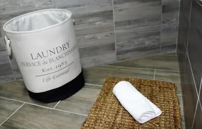 a roll of toilet paper sitting next to a bucket at @Home in the East in Pretoria