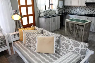 a couch with pillows on it in a kitchen at @Home in the East in Pretoria