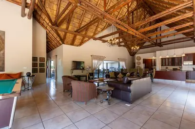 a large living room with a wooden ceiling at Zebula - HT1 - 5 Bedroom Holiday Home in Mabula
