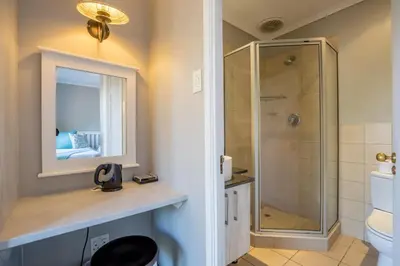 a bathroom with a shower and a toilet at Unit 12, Greenway Woods, White River in Die Winkler