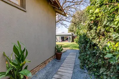 a walkway next to a house with plants at The Hideaway in Benoni