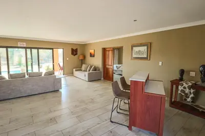 a living room with a couch and a table at Golden Impalas Bush Resort in Hammanskraal