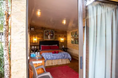 a bedroom with a bed in a small room at Blyde Africa- Cottage in Benoni