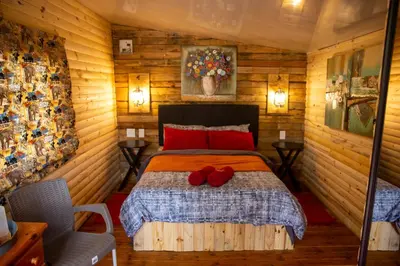 a bedroom with a bed with red pillows on it at Blyde Africa- Cottage in Benoni