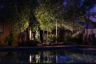 a house with a pool of water in a yard at Blyde Africa- Cottage in Benoni