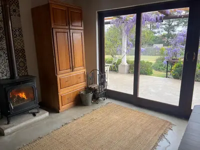 a living room with a fireplace and a wood stove at Apple and Rose in Belfast